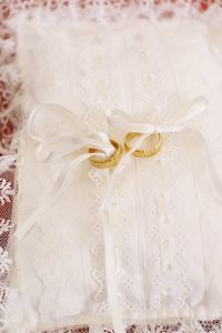 Close-up of wedding rings on white fabric
