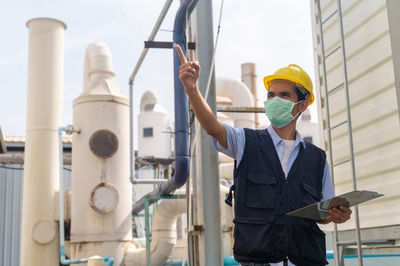 Portrait of young man standing in factory