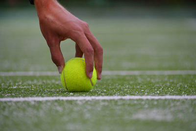Close-up of hand holding ball
