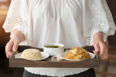 Midsection of woman serving food