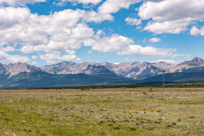 Scenic view of field and mountains against sky