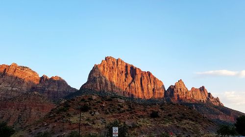 Low angle view of rock formations against sky