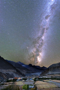 Scenic view of mountains against sky at night