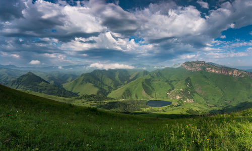 Scenic view of landscape and mountains against sky