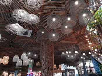 Low angle view of illuminated pendant lights hanging from ceiling