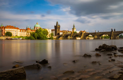 View of bridge over river against buildings