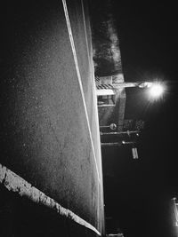 Illuminated road against sky at night