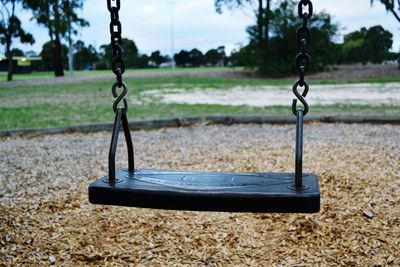 Close-up of swing over field