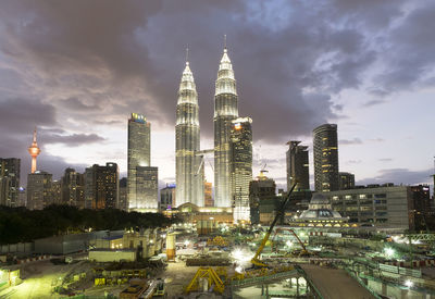 Modern cityscape against cloudy sky