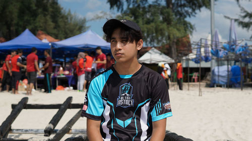 Portrait of young man standing on land