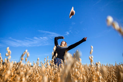 Low angle view of person on field against sky