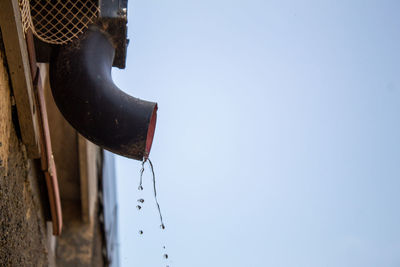 Low angle view of clothes hanging against clear sky