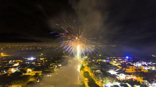 Low angle view of firework display at night