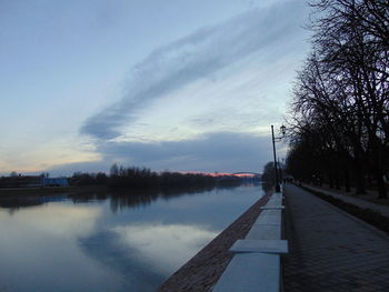 Empty road against cloudy sky