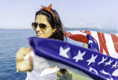 Young woman holding american flag