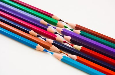 Close-up of colored pencils against white background