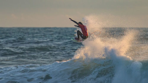 People surfing in sea