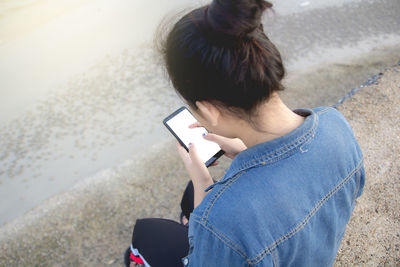 High angle view of woman using mobile phone