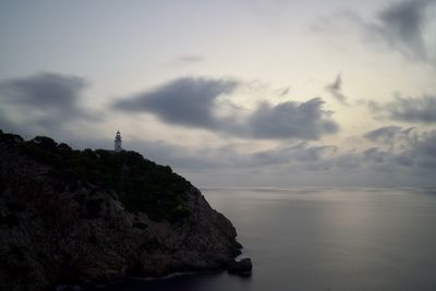 Rock formations by sea against sky