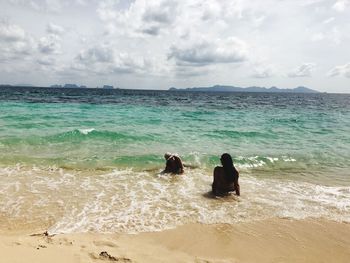 People on beach against sky