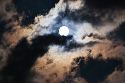 Low angle view of moon against cloudy sky