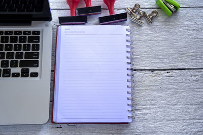 High angle view of laptop and book on table