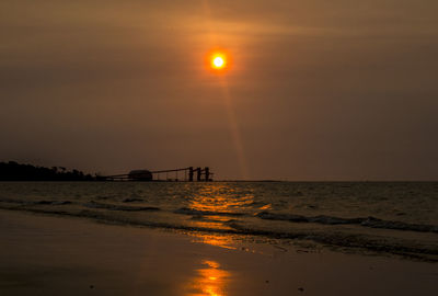 Scenic view of sea against orange sky