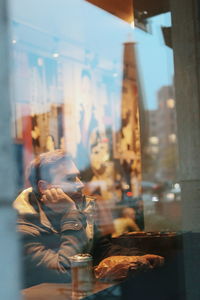 Close-up of man sitting in window