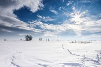 Scenic view of snow covered landscape against sky