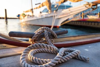 Close-up of rope tied on boat moored at harbor