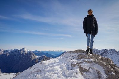 Smiling young woman stands on a rock at skiing area  mountain zugspitze