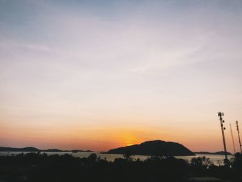 Scenic view of silhouette mountains against sky at sunset