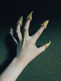 High angle view of woman feet on hand