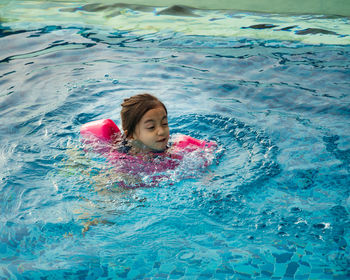 High angle view of girl swimming in pool