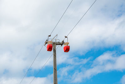 Low angle view of telephone pole against sky