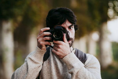 Portrait of young man photographing