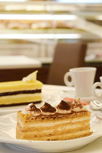 Close-up of cake with coffee on table