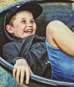 Portrait of smiling boy sitting outdoors