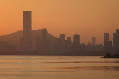 Scenic view of buildings against sky during sunset