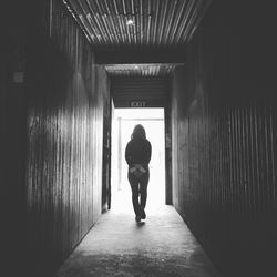 Full length of woman walking in tunnel