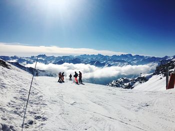 People skiing on snow covered mountain