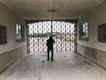 Full length rear view of man walking in building