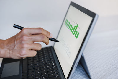 Close up of unrecognizable woman working on financial data with computer. analyzing graphics