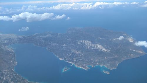 Aerial view of sea and mountains against sky