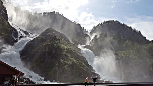 Scenic view of waterfall against sky