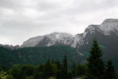 Scenic view of mountains against cloudy sky