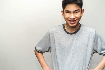 Portrait of a smiling young man against white background