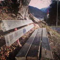 High angle view of bench on field by road