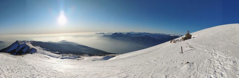 Scenic view of snowcapped mountains against clear blue sky