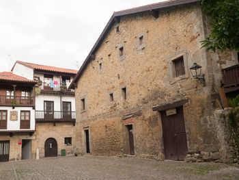 Exterior of old building in town against sky